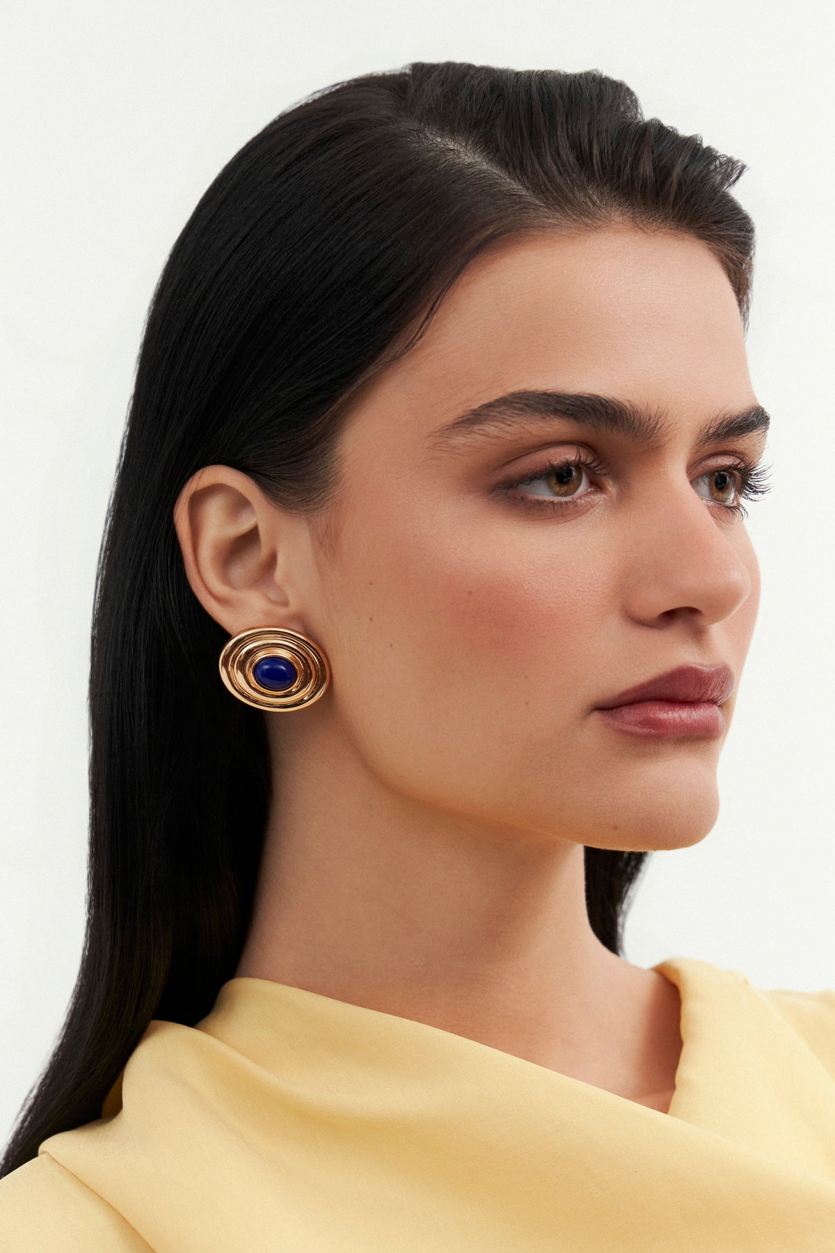 Model wearing Bossa maxi earrings by Balbino